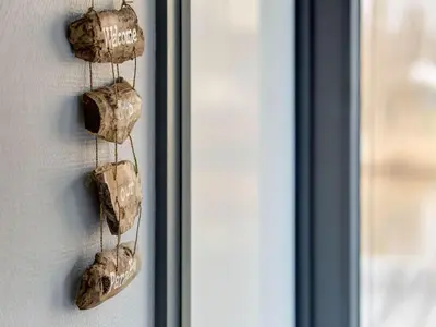 a bunch of wine bottles hanging on a door at Houseboat in Volendam near Fort Edam in Volendam