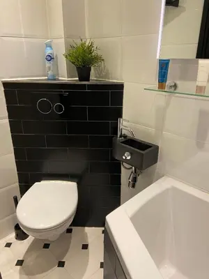 a bathroom with a toilet and a sink and a tub at Apartment Malisa in Zandvoort