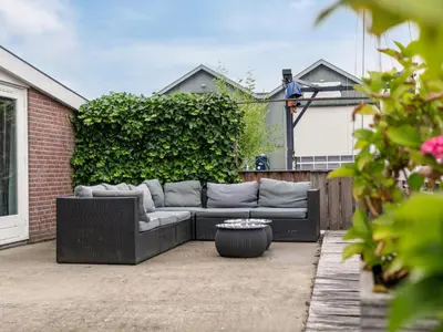 a couch sitting on top of a patio at Zwaan 24-7 in Breukelen