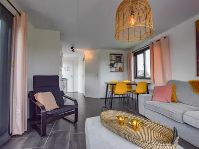 a living room with a couch and a table at Blauwborst 24-24 in Breukelen