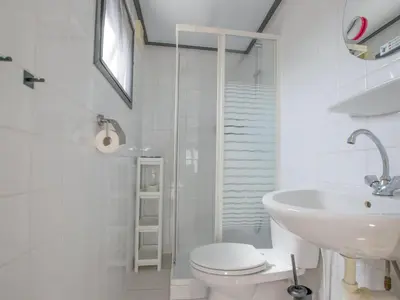a white bathroom with a toilet and a sink at Blauwborst 24-20 in Breukelen