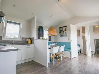 a kitchen with a white refrigerator and a table at Purperreiger 24-34 in Breukelen