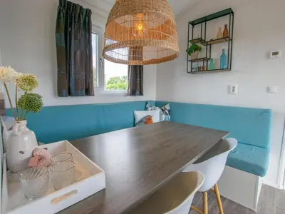 a dining room with a table and a chandelier at Purperreiger 24-32 in Breukelen