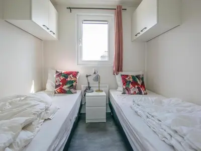 a bedroom with two beds and a window at Grote Karekiet 24-22 in Breukelen
