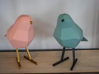 two birds sitting on top of a wooden table at Grote Karekiet 24-22 in Breukelen