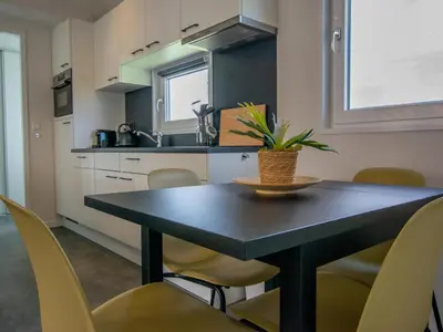 a kitchen with a table with chairs and a plant on it at Grote Karekiet 24-22 in Breukelen