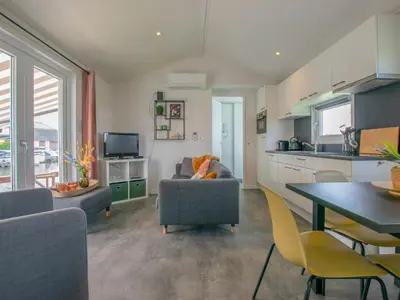 a living room with a couch and a table at Grote Karekiet 24-30 in Breukelen