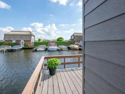 a wooden dock with boats in the water at Grote Karekiet 24-30 in Breukelen