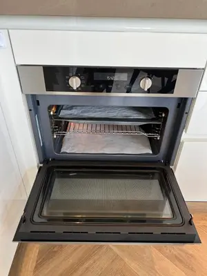 an oven with its door open in a kitchen at NEW - Private Residence with Sauna - on a lake near Amsterdam in Vinkeveen