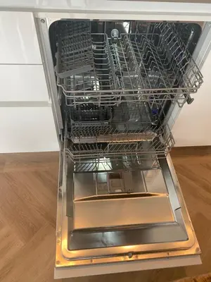 a dishwasher with its door open on a wooden floor at NEW - Private Residence with Sauna - on a lake near Amsterdam in Vinkeveen