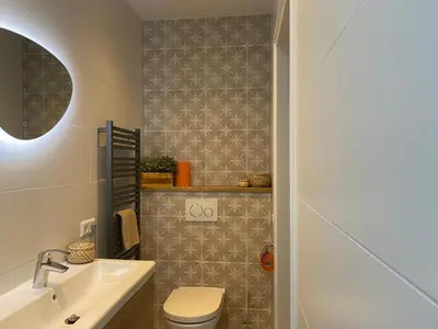 a bathroom with a toilet and a sink at Northgo apartment in Noordwijk