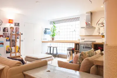 a living room with couches and a kitchen at Flo's Atelier - Family studio NOTE studio is adjacent to Flo's apartment in Amsterdam