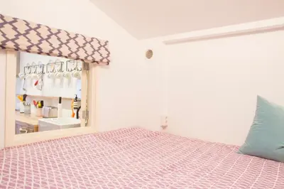 a bedroom with a bed and a mirror at Flo's Atelier - Family studio NOTE studio is adjacent to Flo's apartment in Amsterdam