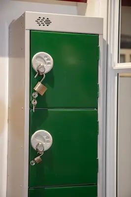 a green door with locks on it in a building at Flo's Atelier - Family studio NOTE studio is adjacent to Flo's apartment in Amsterdam