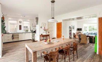 a kitchen and dining room with a wooden table and chairs at Vakantiehuis Zeevonk in Bergen aan Zee