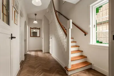 a hallway with stairs and a window at Vakantiehuis Zeevonk in Bergen aan Zee