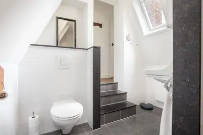 a bathroom with a toilet and a sink at Vakantiehuis Zeevonk in Bergen aan Zee