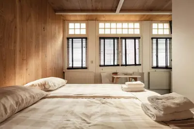 a large bed in a room with windows at New! Private Authentic Apartment In City Centre! in Amsterdam