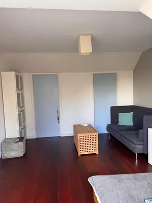 a living room with a couch and a table at Villa Cosy Central incl Jacuzzi Near trainstation, beach and city in Heemstede
