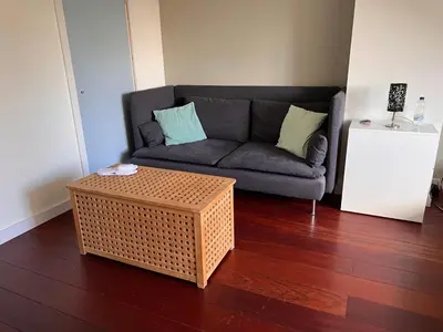 a living room with a couch and a coffee table at Villa Cosy Central incl Jacuzzi Near trainstation, beach and city in Heemstede