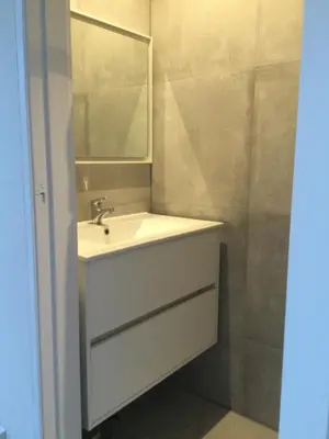 a bathroom with a white sink and a mirror at Villa Cosy Central incl Jacuzzi Near trainstation, beach and city in Heemstede