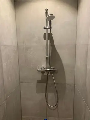 a shower stall with a shower head in a bathroom at Villa Cosy Central incl Jacuzzi Near trainstation, beach and city in Heemstede