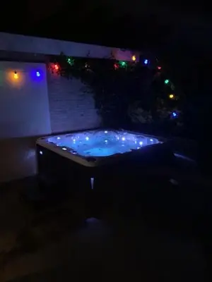 a jacuzzi tub lit up at night with lights at Villa Cosy Central incl Jacuzzi Near trainstation, beach and city in Heemstede
