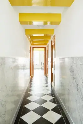 a hallway with a black and white checkered floor at Modern Canal House Loft - City Center in Amsterdam