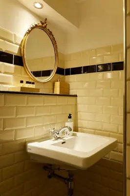 a bathroom with a sink and a mirror at Modern Canal House Loft - City Center in Amsterdam