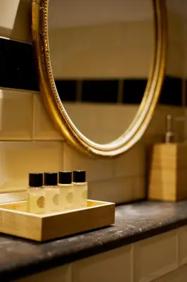 a bathroom counter with a mirror and a box of soap at Modern Canal House Loft - City Center in Amsterdam