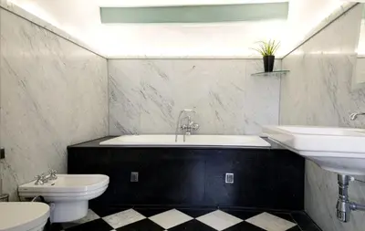 a bathroom with a tub and a toilet and a sink at Modern Canal House Loft - City Center in Amsterdam