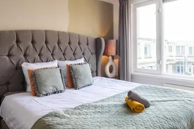 a bedroom with a large bed with a large window at Big Room in Amsterdam
