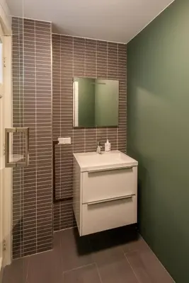 a bathroom with a white sink and a mirror at Big Room in Amsterdam