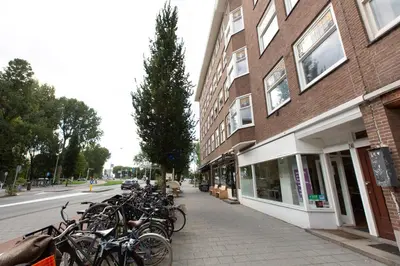 a row of bikes parked on a sidewalk next to a building at Big Room in Amsterdam