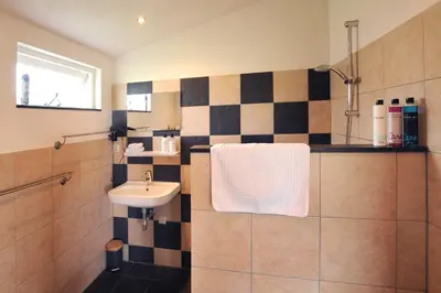 a bathroom with a sink and a shower with a sink at Chalet Egmond in Egmond aan den Hoef