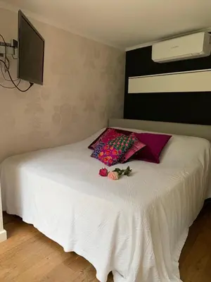 a bedroom with a white bed with flowers on it at Place To Be in Naarden