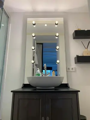 a bathroom sink with a large mirror above it at Place To Be in Naarden