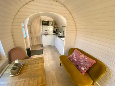 a small living room with a couch and a table at Bed & Wellness Klein Knorrestein with private hottub and sauna and tandembike rental included in price in Almere