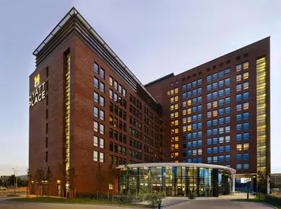 a large brick building with a sign on it at Hyatt Place Amsterdam Airport in Hoofddorp