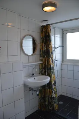 a bathroom with a sink and a mirror at Seapaerdje in Bergen aan Zee