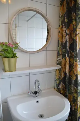 a bathroom with a sink and a mirror at Seapaerdje in Bergen aan Zee