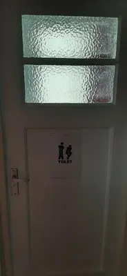 a bathroom door with a window above it at NICOLE, not for parties, not a hotel, room with shared bathroom, no kitchen in Amsterdam