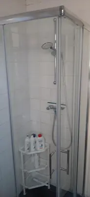 a shower with a glass door in a bathroom at NICOLE, not for parties, not a hotel, room with shared bathroom, no kitchen in Amsterdam