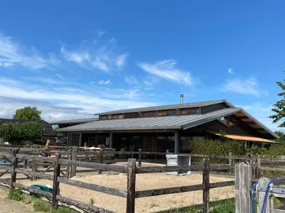 a building with a fence in front of it at Hestar Husid, het luxe paardenhuis in Weesp