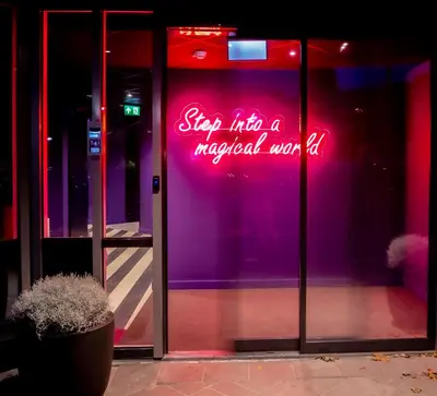 a neon sign on the side of a building at Hotel VIC in Leiden