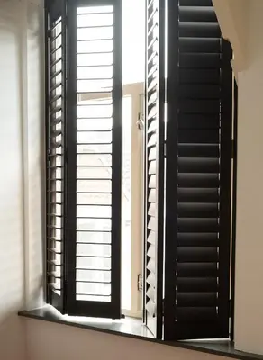 a window with black shutters in a room at Bed and Breakfast du Parc in Zaandam