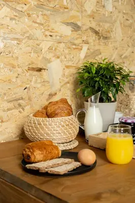 a table with bread and eggs and a glass of orange juice at Bed and Breakfast du Parc in Zaandam