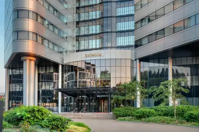 a tall building with a sign on it at Corendon Amsterdam Schiphol Airport, a Tribute Portfolio Hotel in Badhoevedorp
