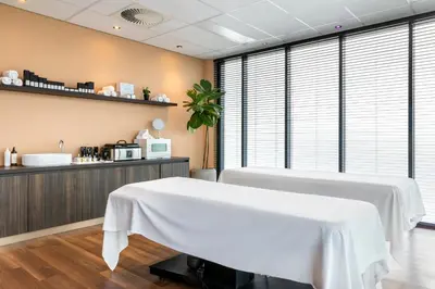 a room with a white table in front of a counter at Residence Inn by Marriott Amsterdam Schiphol Airport in Badhoevedorp
