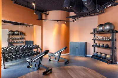 a gym with dumbbells and a table in a room at Residence Inn by Marriott Amsterdam Schiphol Airport in Badhoevedorp